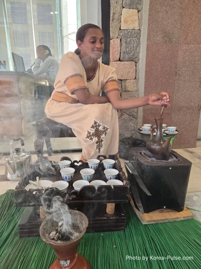 BTS Is Back: A Global Dad's Perspective from the Heart of Seoul 2 A woman preparing traditional Ethiopian coffee during a ceremony