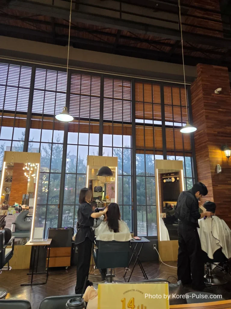 Window-side seating area at idHAIR One Mount with natural light and open salon floor