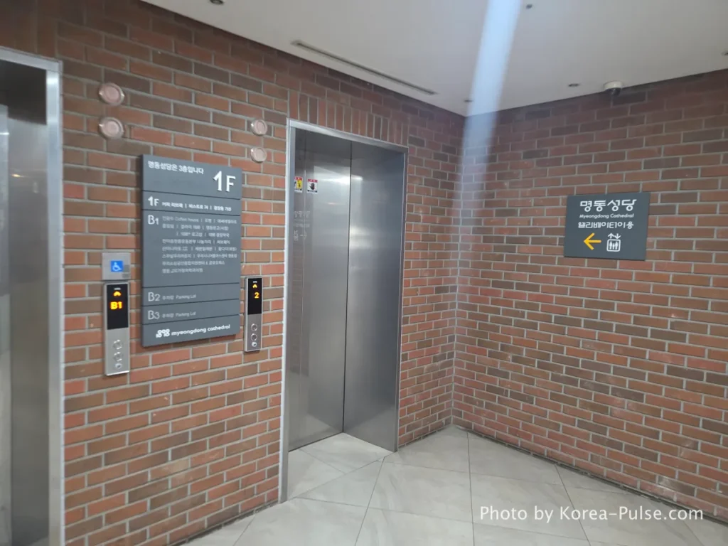 Myeongdong Cathedral: Seoul's Gothic Soul, Hidden Above the Shopping District 4 Elevator lobby inside 1898 Plaza below Myeongdong Cathedral — access to cathedral grounds on 3rd floor