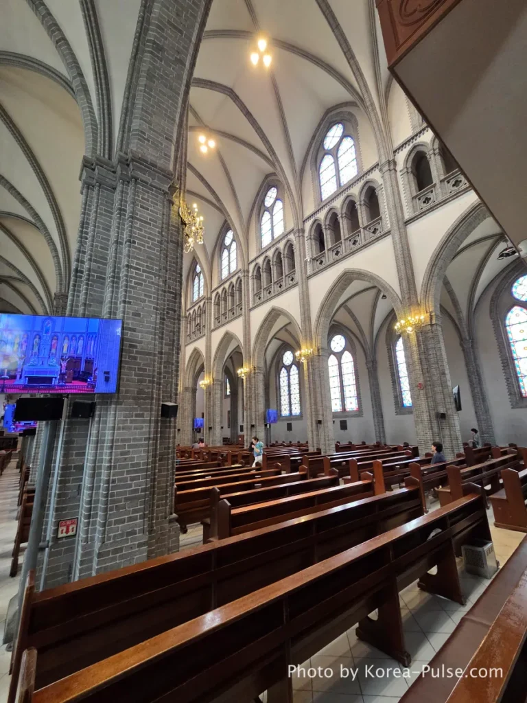 Myeongdong Cathedral: Seoul's Gothic Soul, Hidden Above the Shopping District 9 Myeongdong Cathedral interior viewed from front toward rear — showing choir loft, Gothic vaulting and full length of nave