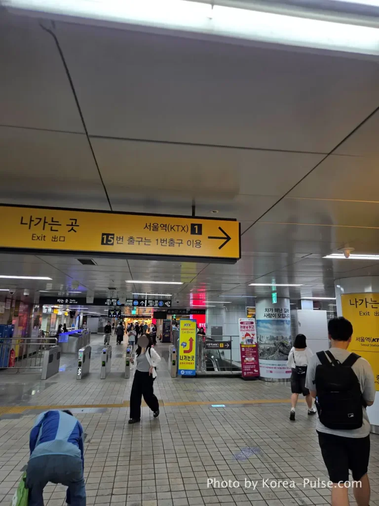 GTX-A Seoul Guide: Korea's Deep Underground Express from Daegok to Seoul Station 10 Underground directional signage at Seoul Station pointing toward KTX Exit 1 after arriving on GTX-A