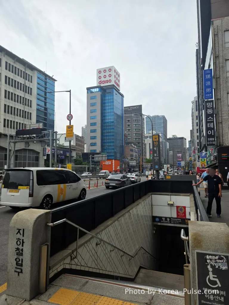 Daiso Myeongdong Station branch 12-story glass tower building exterior street view Seoul landmark