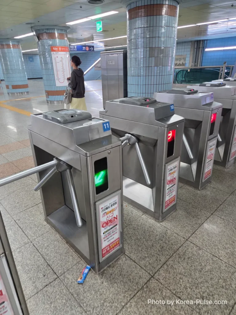 How to Buy a Seoul Subway Ticket: Step-by-Step Guide for Foreigners (2026) 10 Passenger tapping single journey ticket at Seoul Metro fare gate to enter subway station