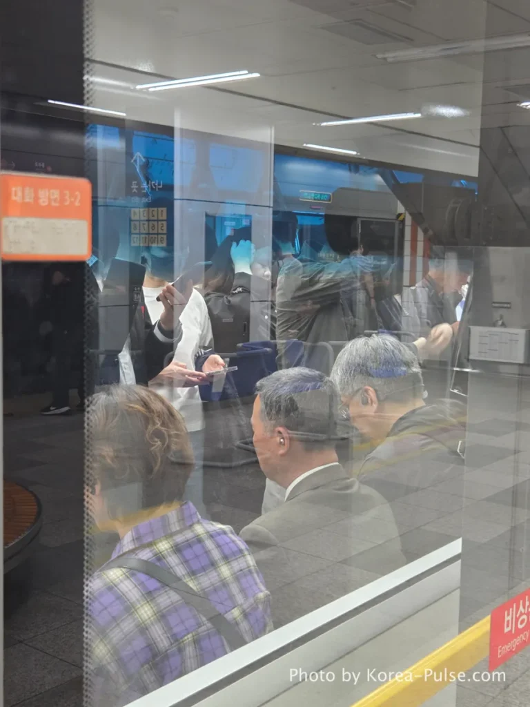 Inside Seoul Rush Hour: Why Korea's Subway System Feels Different 6 Seoul Metro Line 3 train interior viewed through glass partition, passengers standing during evening commute