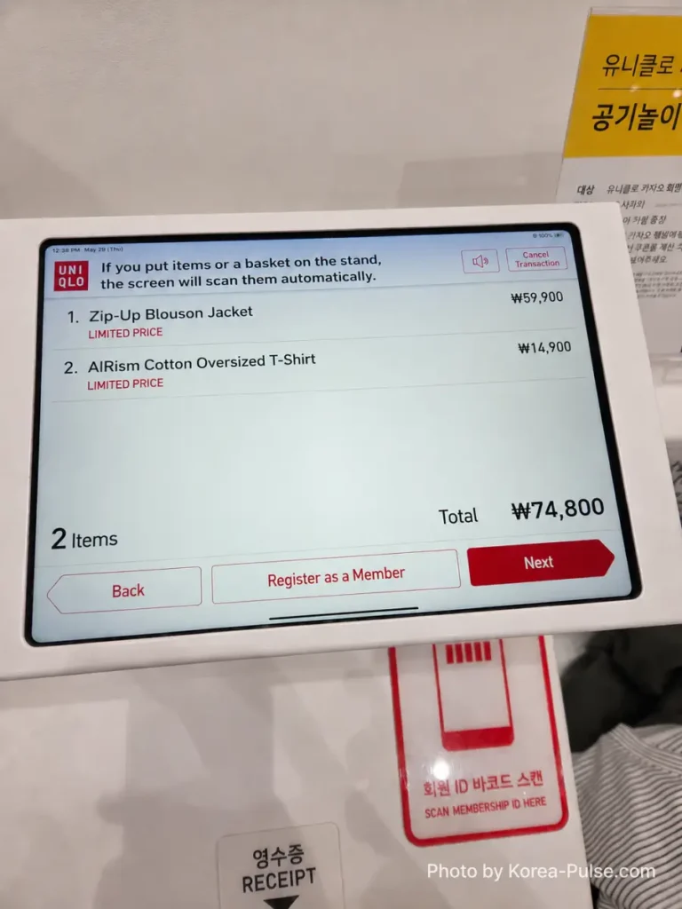 Uniqlo self-checkout screen showing the final purchase of a Zip-Up Blouson Jacket at 59,900 won and an AIRism Cotton Oversized T-Shirt at 14,900 won, totaling 74,800 won, with both items marked as Limited Price