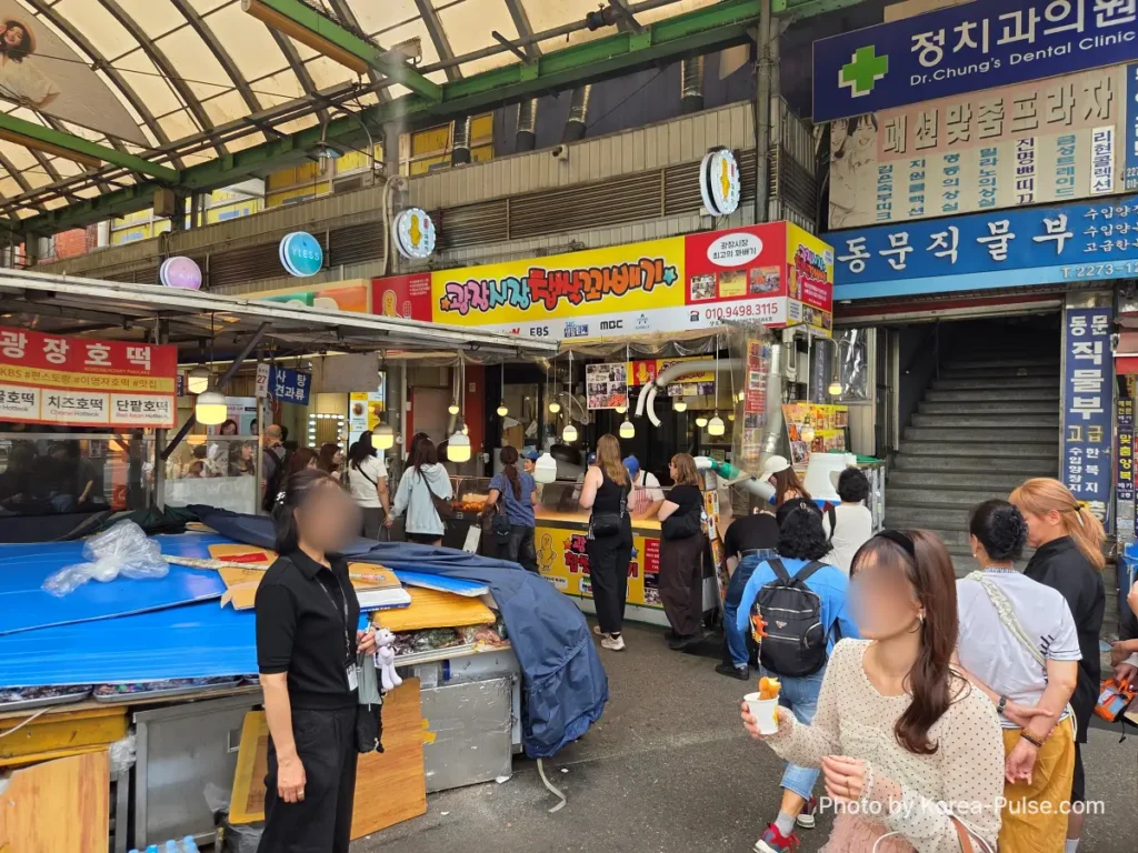 Gwangjang Market Seoul: The Complete Entry Guide — Part 1 5 North Gate 2 entrance of Gwangjang Market Seoul with 광장시장 sign and covered market arcade stretching inside