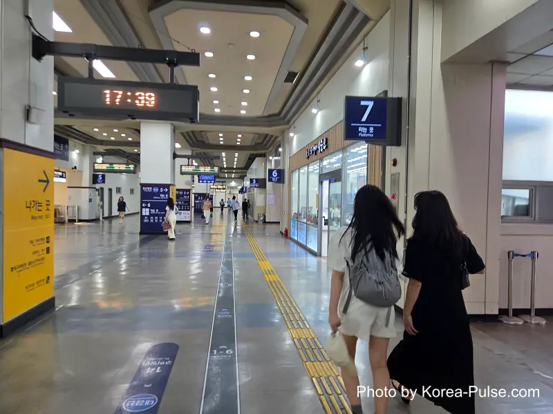 Dongdaegu to Andong Train: Riding Korea's Classic Mugunghwa 8 Family walking through Dongdaegu Station overhead corridor toward Platform 1 at 17:39