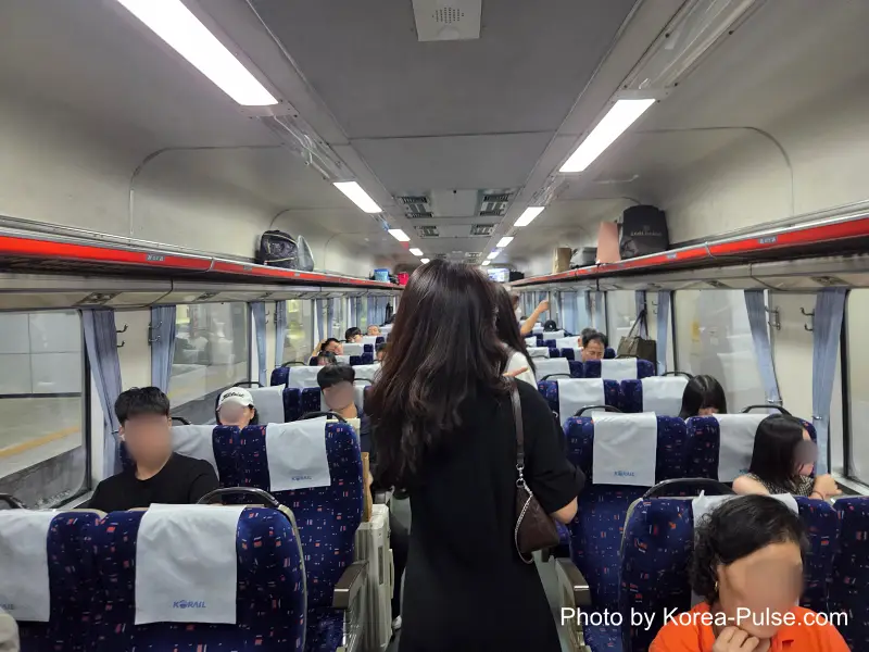 Dongdaegu to Andong Train: Riding Korea's Classic Mugunghwa 9 Dongdaegu to Andong train Mugunghwa interior blue fabric seats Korail headrest covers passengers