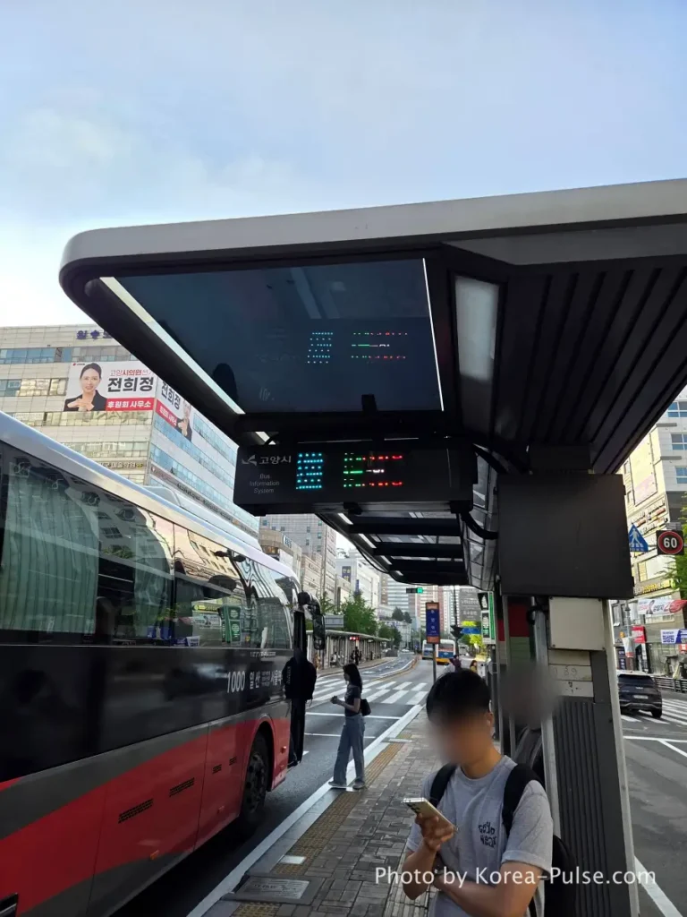 Ilsan BRT central lane bus shelter showing Bus Information System BIS electronic display board mounted on canopy ceiling