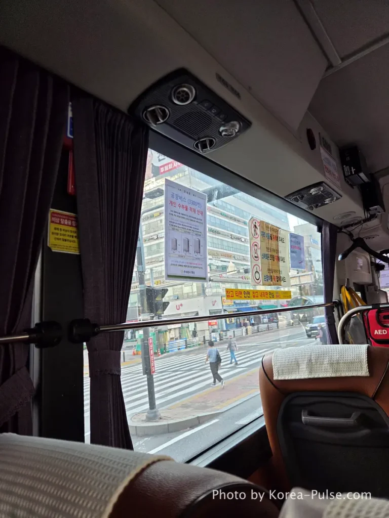 Interior view from seat on Airport Bus 3300 showing highway ahead through front windshield on way to Incheon Airport