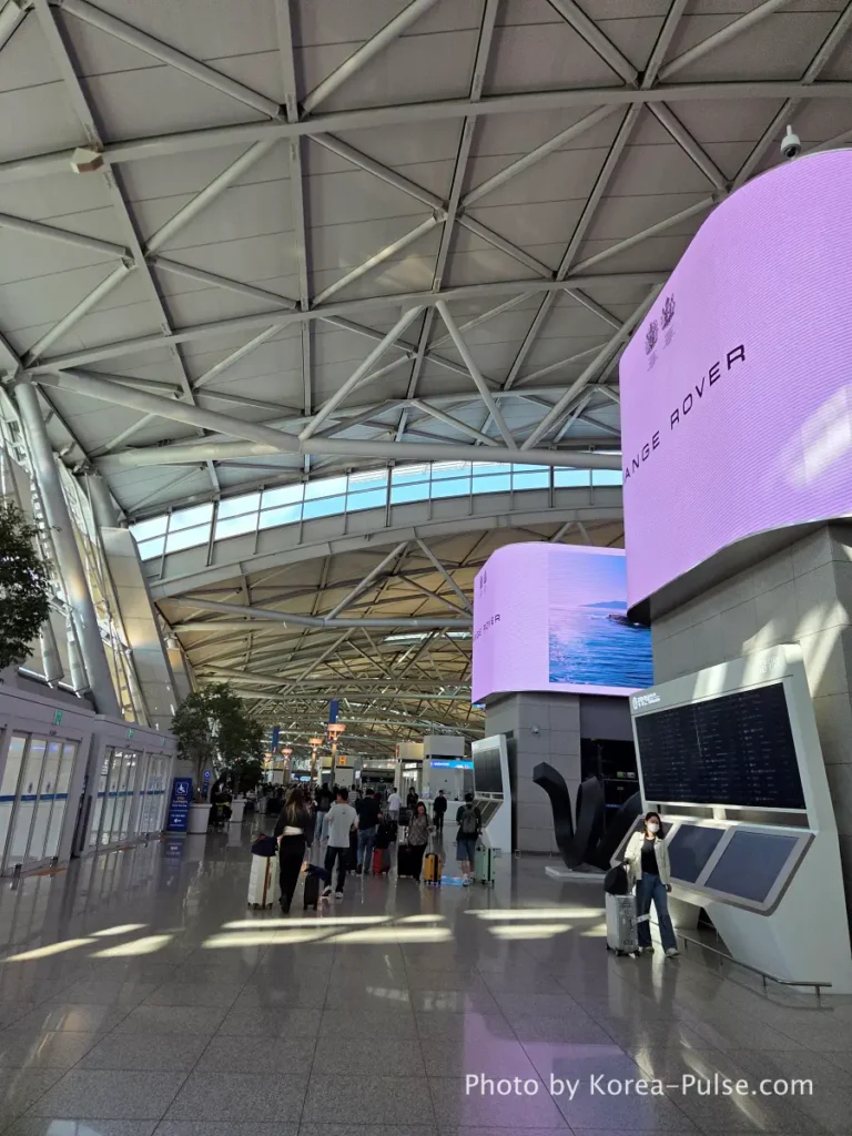Incheon Airport Terminal 1 departures hall interior early morning with passengers and check-in counters