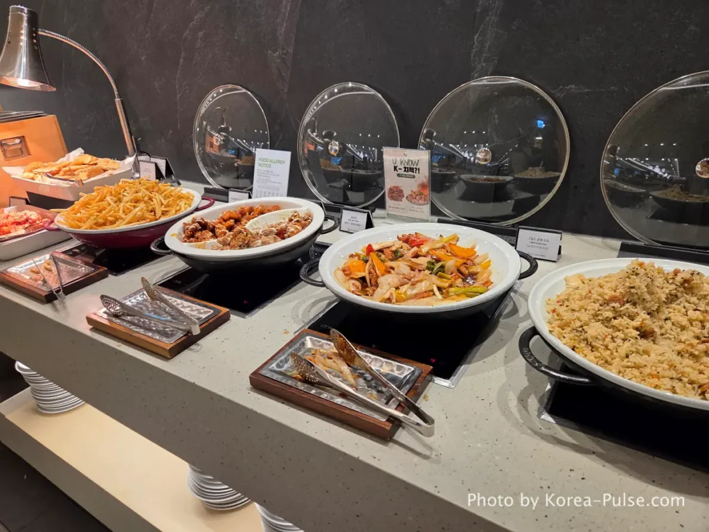 Incheon Airport Smartpass: Skip the Line & Hit the Lounge Fast 13 SKYHUB Lounge buffet spread at Incheon Airport with stir-fried rice grilled duck chicken and side dishes
