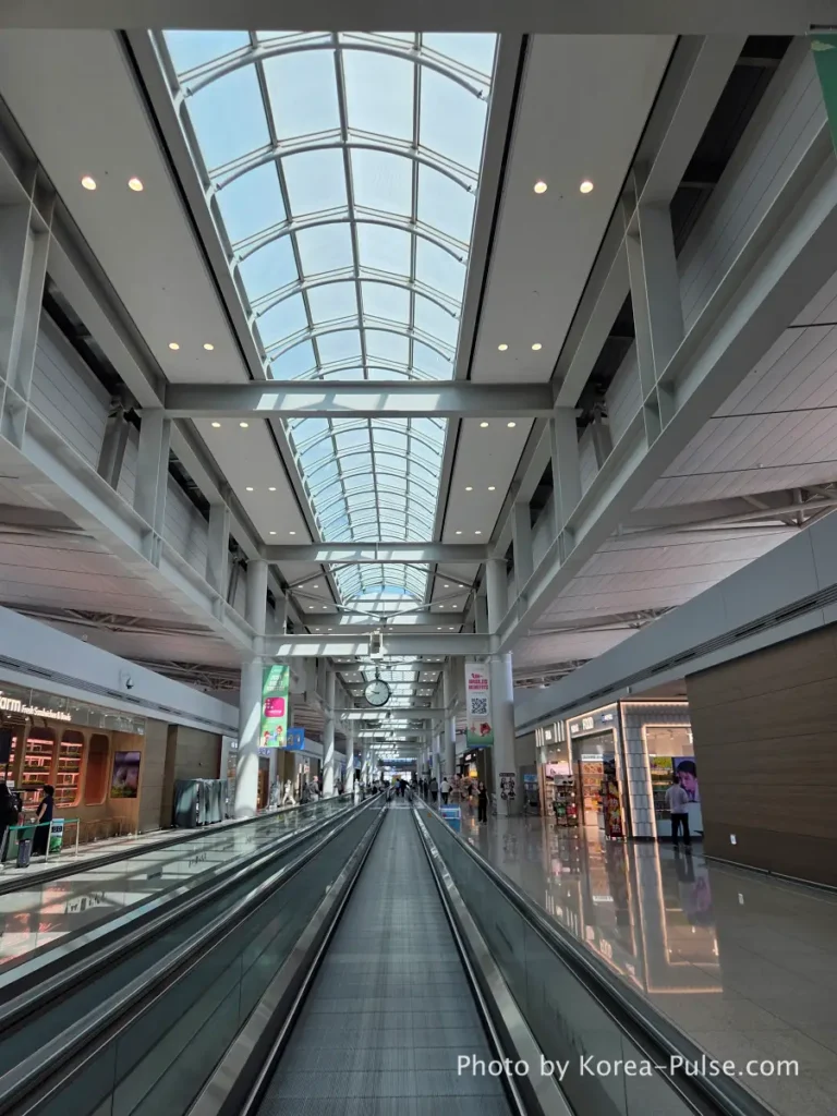 Incheon Airport Smartpass: Skip the Line & Hit the Lounge Fast 15 Incheon Airport Terminal 1 gate corridor with high arched glass ceiling and moving walkways toward departure gates