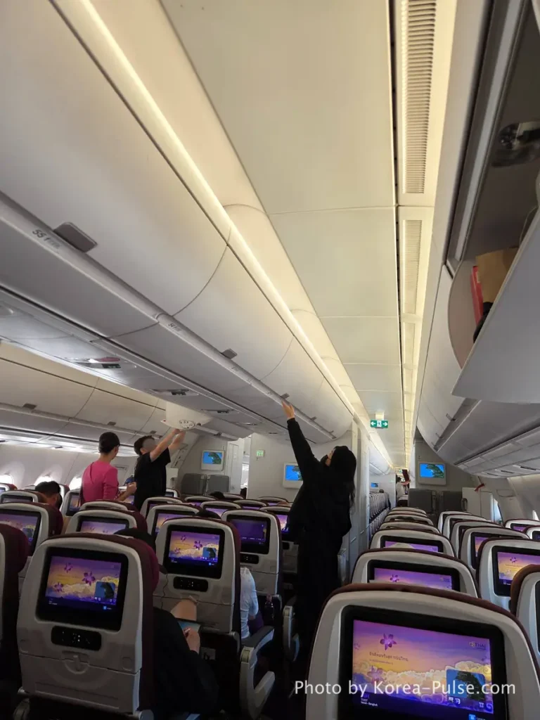 Incheon Airport Smartpass: Skip the Line & Hit the Lounge Fast 16 Thai Airways cabin interior with purple seat covers and personal screens showing Thai art before departure