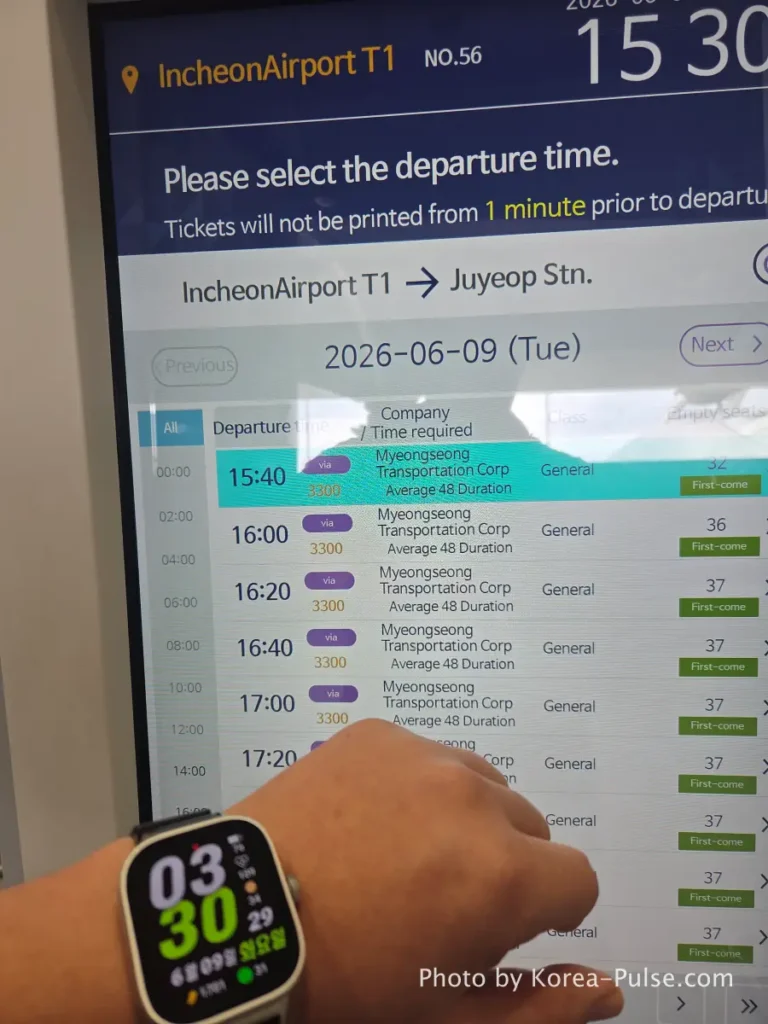 Incheon Airport Arrival Guide: Plane to Bus in Under an Hour 18 Hand selecting 3:40pm departure time on airport bus kiosk after checking watch showing 3:30pm at Incheon Airport