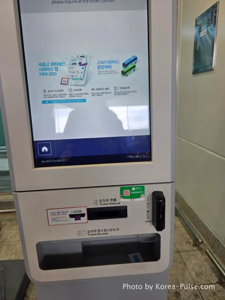 Incheon Airport Arrival Guide: Plane to Bus in Under an Hour 22 Hand collecting printed airport bus ticket from receipt slot of kiosk at Incheon Airport Terminal 1