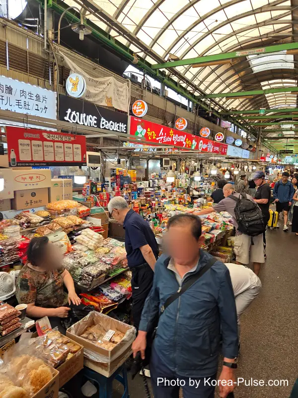 Gwangjang Market food alley traditional Korean candies and misutgaru grain powder stall on left side