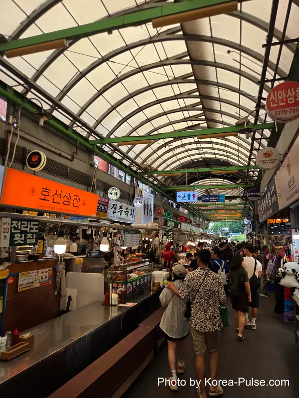 Gwangjang Market South Gate 1 stall with fresh hoe raw fish sundae and fruit juice display