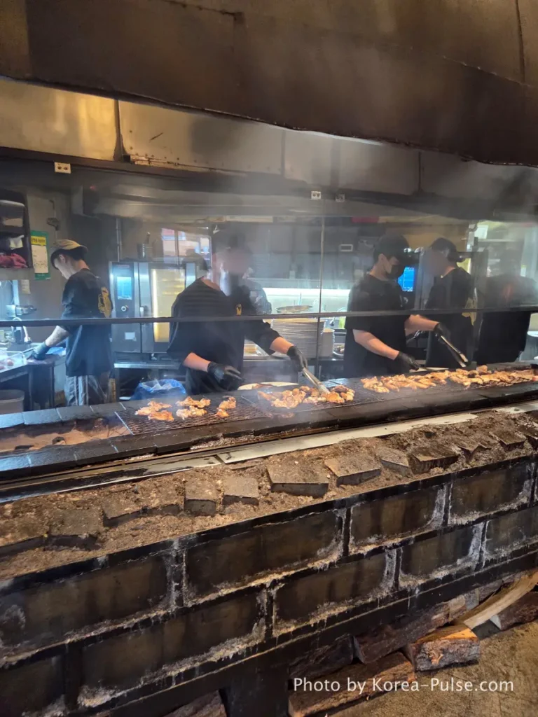Euljiro Outdoor Dining: TOP 5 Where Seoul's Office Workers Actually Go 2 Dalmaji Plaza BBQ charcoal grill workers grilling chicken and sausages Euljiro Seoul