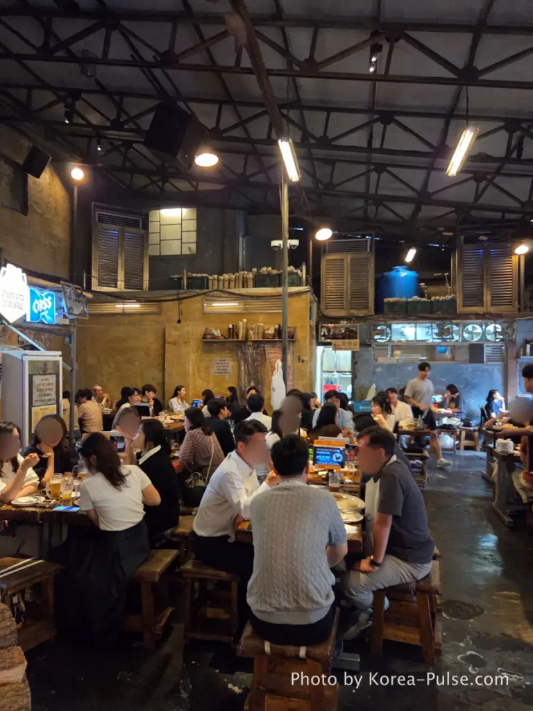 Euljiro Outdoor Dining: TOP 5 Where Seoul's Office Workers Actually Go 4 Dalmaji Plaza BBQ indoor seating packed with diners Euljiro Seoul Friday evening