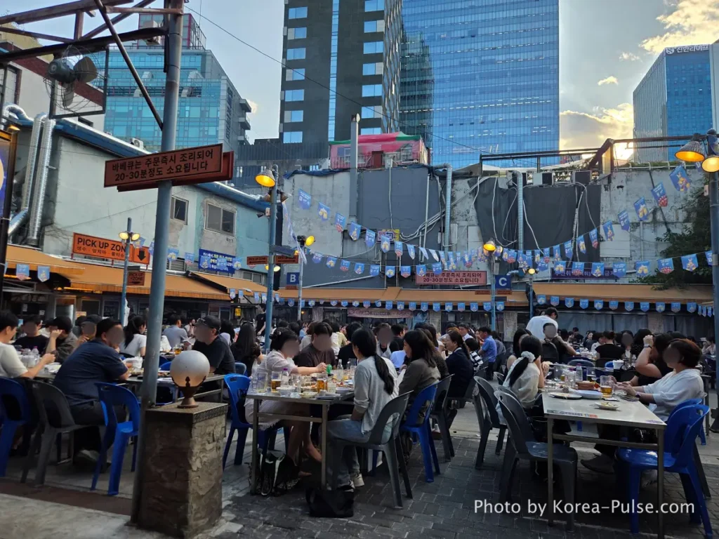 Euljiro Outdoor Dining: TOP 5 Where Seoul's Office Workers Actually Go 6 Dalmaji Plaza BBQ yajang packed outdoor seating Euljiro Seoul Friday night