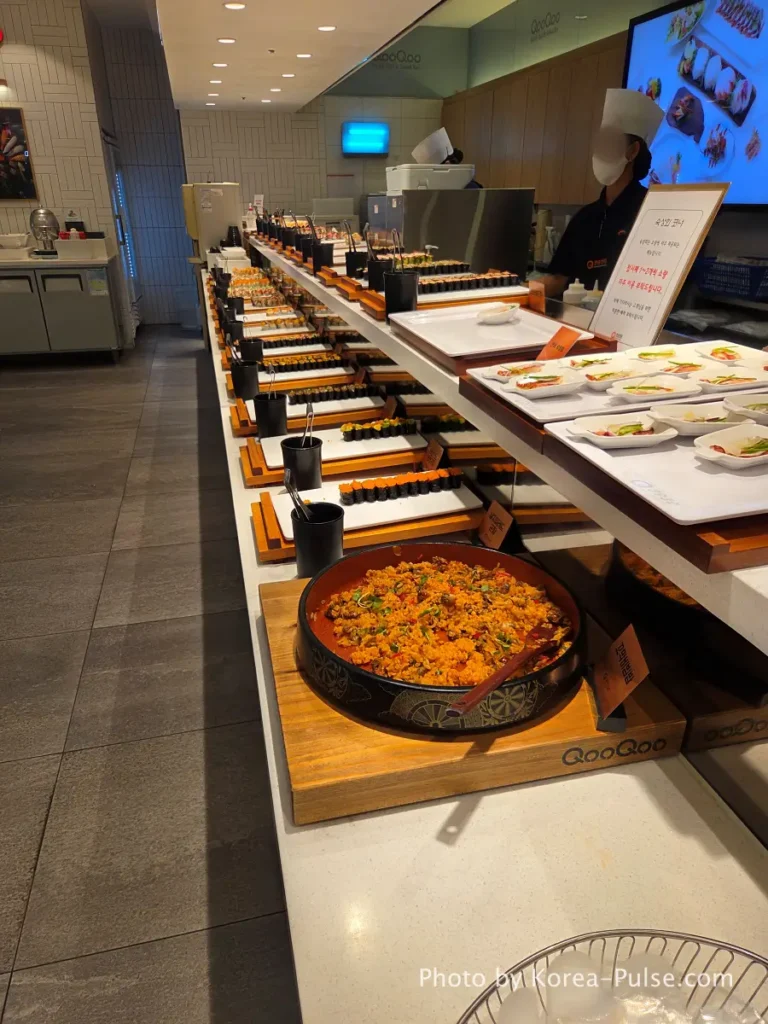 Gunkan zone and aged sashimi corner along the counter at QooQoo