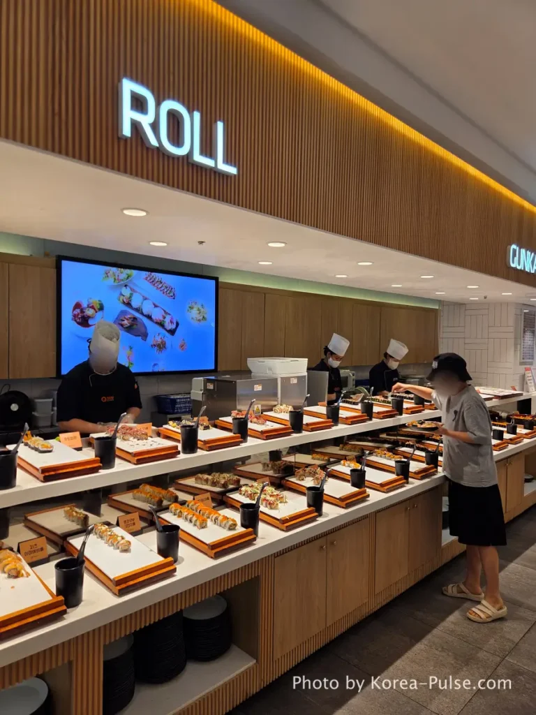 Roll zone counter with chef preparing sushi rolls at QooQoo