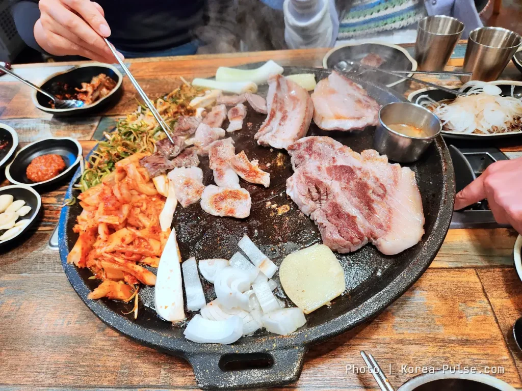 K-BBQ Etiquette Without the Anxiety: How to Grill, Share, and Read the Table Like a Local 1 K-BBQ etiquette with pork belly, kimchi and diners sharing a tabletop grill
