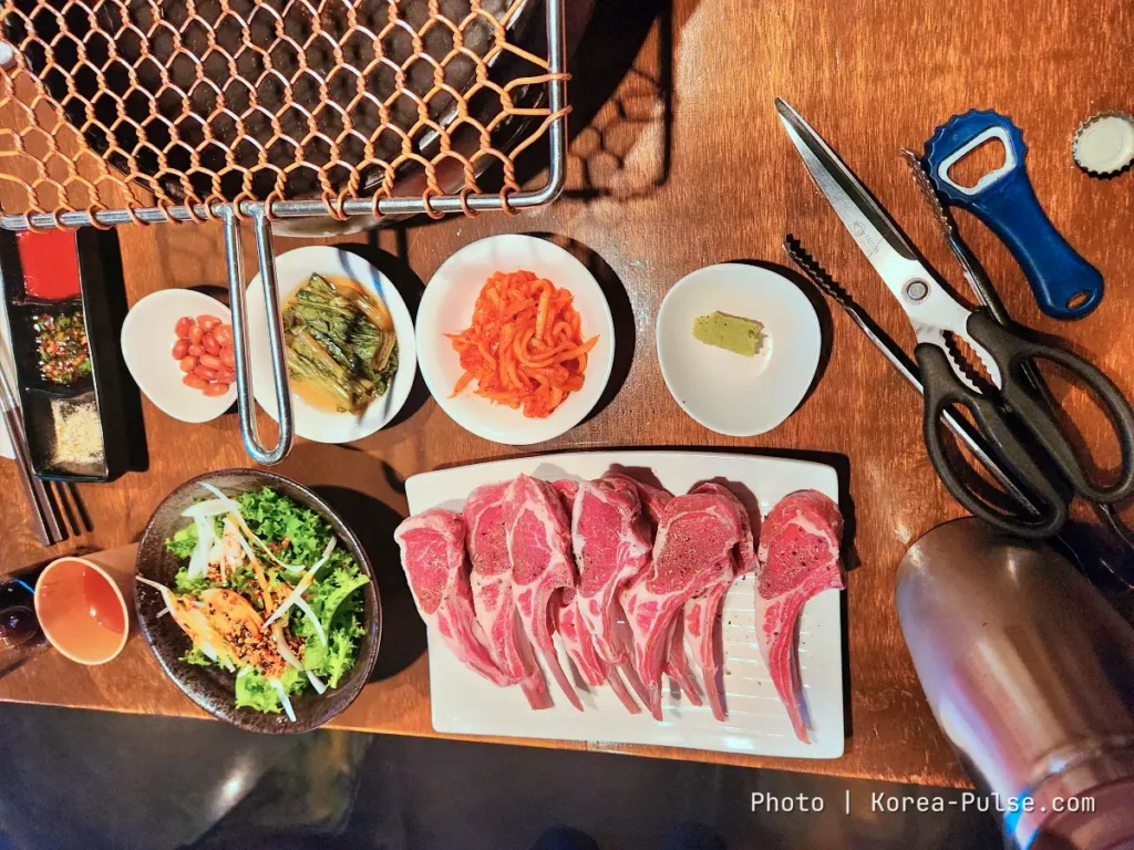 K-BBQ Etiquette Without the Anxiety: How to Grill, Share, and Read the Table Like a Local 3 Korean barbecue table with lamb chops, kitchen scissors, tongs and banchan