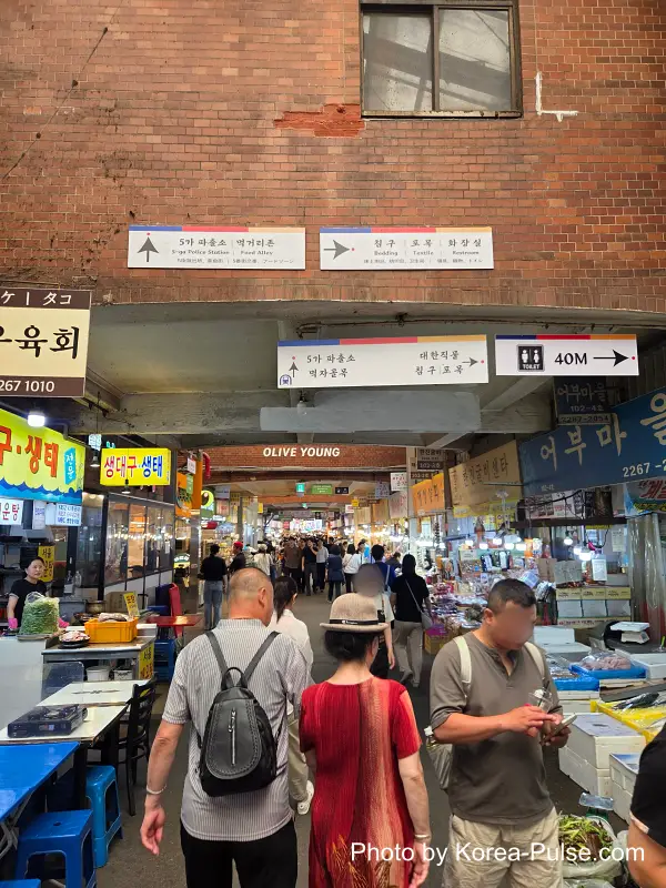 Seafood stalls next to fabric shops in Gwangjang Market's textile district