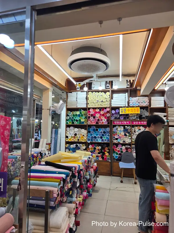 Tailoring shop textile rolls in Gwangjang Market's hanbok alley