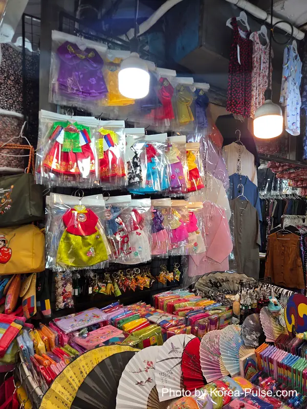 Traditional fans and pouches in Gwangjang Market's hanbok alley