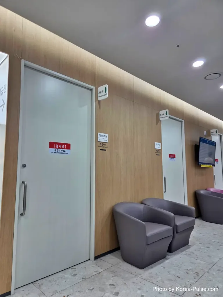Corridor with a radiation warning sign outside an ultrasound and imaging examination room