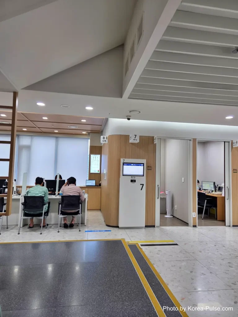 Vision test station at a Korean health checkup center with an eye chart and automated testing machines