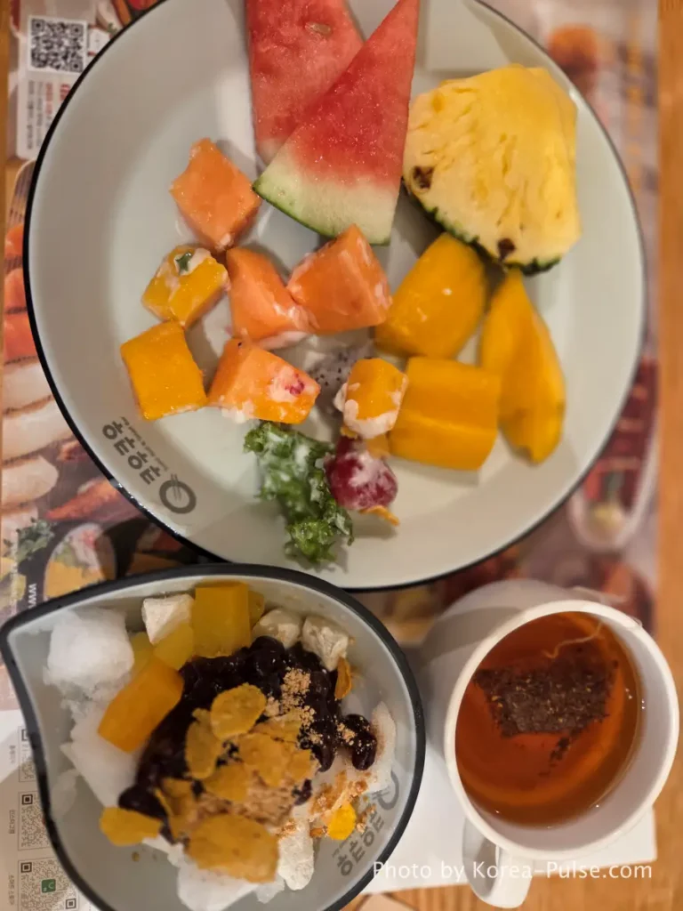 Final dessert plate with watermelon pineapple mango and patbingsu at QooQoo